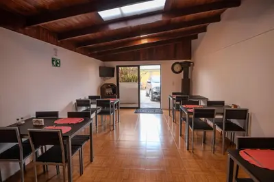 a restaurant with tables and chairs in a room at Hotel las Ardillas Monteverde in Monteverde Costa Rica