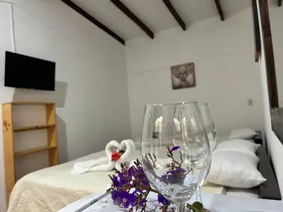 a table with a wine glass and flowers on it at Hotel las Ardillas Monteverde in Monteverde Costa Rica