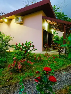 a small house with red flowers in front of it at Villa Tucan in Fortuna
