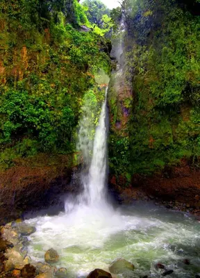 a painting of a waterfall on the side of a river at Hotel Mango Valley in Grecia