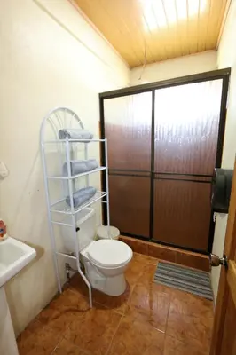 a small bathroom with a toilet and a shower at Casa Cattleya - Monteverde, Costa Rica in Monteverde Costa Rica