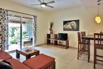 a living room with a couch and a table at Costa Riki Apartments in Santa Teresa Beach