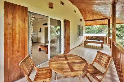 a dining room with a table and two chairs at Costa Riki Apartments in Santa Teresa Beach