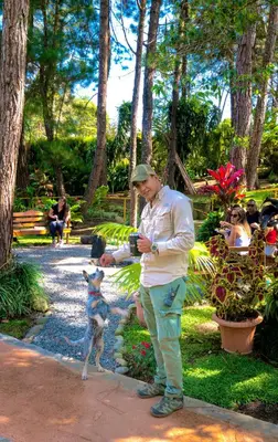 a man standing with a dog in a park at Vista Turrialba Lodge in Turrialba