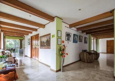 a living room with a vase of flowers on the wall at Terrazas de Golf Boutique Hotel in San José