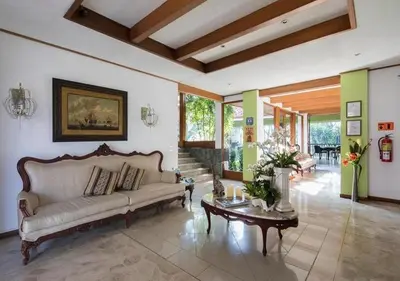 a living room with a couch and a table at Terrazas de Golf Boutique Hotel in San José