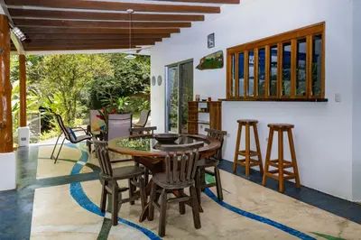 a dining room with a wooden table and chairs at Casa Cedro - Portasol Vacation Rentals in Matapalo