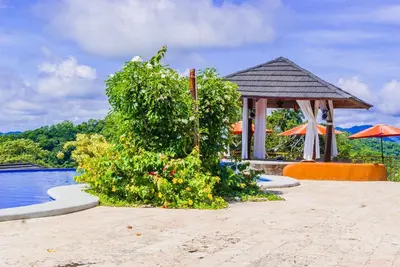 a resort with a gazebo next to a pool at Eco Boutique Hotel Vista Las Islas Reserva Natural in Paquera
