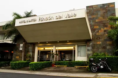 a motorcycle parked in front of a building at Rincon del Valle Hotel & Suites in San José