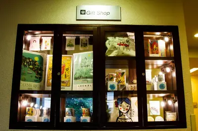 a display case in a store filled with books at Rincon del Valle Hotel & Suites in San José