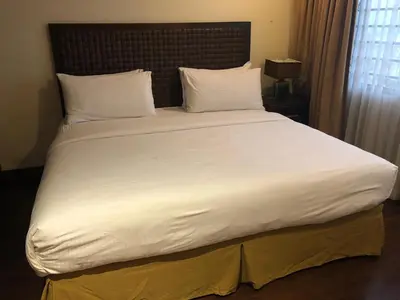 a large white bed in a hotel room at Rincon del Valle Hotel & Suites in San José
