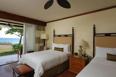 a bedroom with two beds and a view of the ocean at JW Marriott Guanacaste Beach Resort in Tamarindo