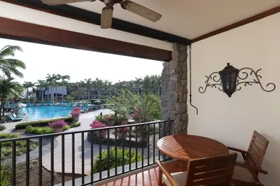 a balcony with a table and a view of a pool at JW Marriott Guanacaste Beach Resort in Tamarindo