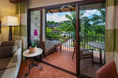 a living room with a couch and a balcony at JW Marriott Guanacaste Beach Resort in Tamarindo