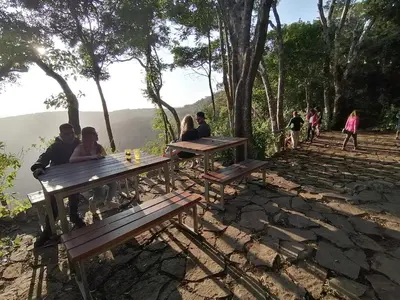 a group of people sitting at picnic tables on a hill at Valle Escondido Nature Reserve Hotel & Farm in Monteverde Costa Rica