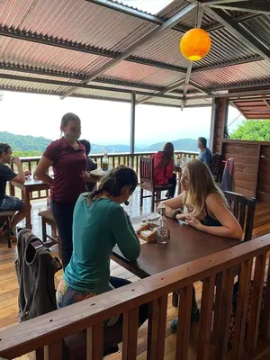 a group of people sitting at a table in a restaurant at Valle Escondido Nature Reserve Hotel & Farm in Monteverde Costa Rica