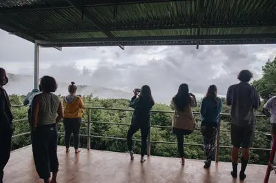 a group of people standing on a viewing deck looking out at the mountains at Valle Escondido Nature Reserve Hotel & Farm in Monteverde Costa Rica