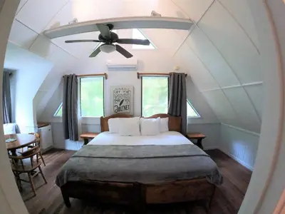 a bedroom with a bed with a ceiling fan at Casa Cecilia Beach Front in Santa Teresa Beach