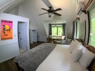 a bedroom with a large bed with a ceiling fan at Casa Cecilia Beach Front in Santa Teresa Beach