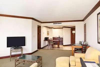 a living room with a large flat screen tv at Wyndham San Jose Herradura in San José