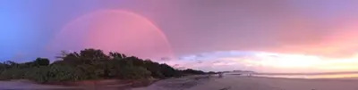 a rainbow in the sky over a beach at Chill-Inn Nosara in Nosara
