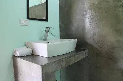 a white sink on a concrete counter in a bathroom at Chill-Inn Nosara in Nosara