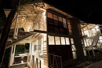 a house with a staircase on the side of it at night at marAmar Bungalows by STH in Santa Teresa Beach