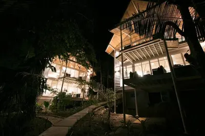 a building at night with the lights on at marAmar Bungalows by STH in Santa Teresa Beach