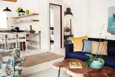 a living room with a blue couch and a table at marAmar Bungalows by STH in Santa Teresa Beach
