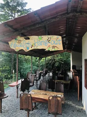 a sign for a hang out with a table and chairs at Above the Gulf, Vacation House in Monteverde Costa Rica