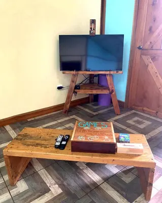 a coffee table with a tv and a cake on it at Above the Gulf, Vacation House in Monteverde Costa Rica