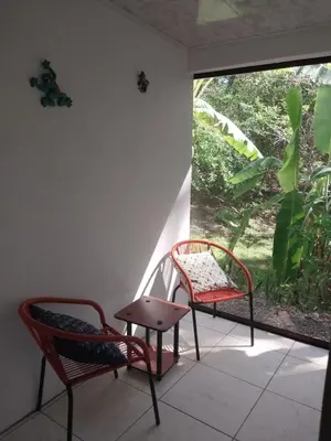 two chairs and a table in a room with a window at Casa Taupe in Carrillo