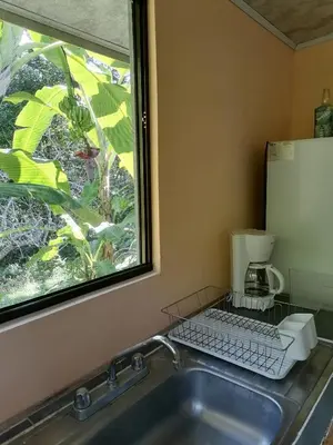 a kitchen sink with a window next to a counter at Casa Taupe in Carrillo