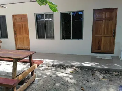 a room with a table and some windows and a door at Casa Taupe in Carrillo
