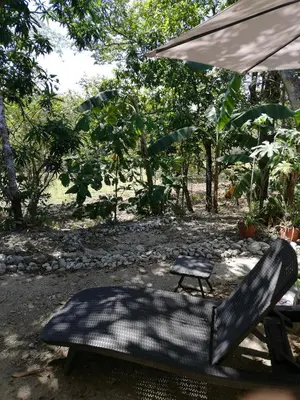 a black chair and an umbrella and a table at Casa Taupe in Carrillo
