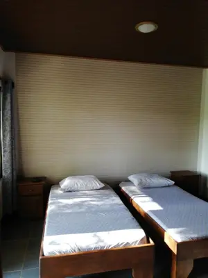 two twin beds in a room with a wall at Casa Taupe in Carrillo