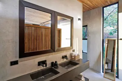 a bathroom with a sink and a mirror at SELVA RESORT Ocean View Luxury Villas in Santa Teresa Beach