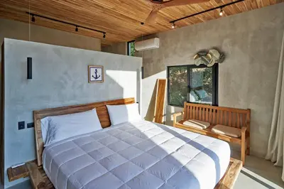 a bedroom with a large white bed and a window at SELVA RESORT Ocean View Luxury Villas in Santa Teresa Beach