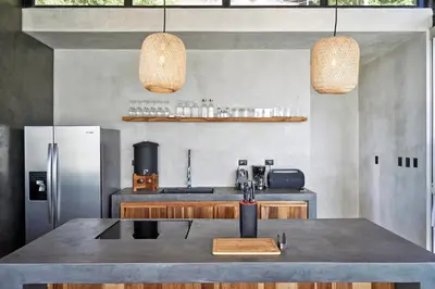 a kitchen with a sink and a refrigerator at SELVA RESORT Ocean View Luxury Villas in Santa Teresa Beach