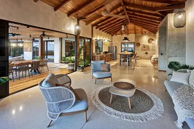 an open living room with chairs and a table at SELVA RESORT Ocean View Luxury Villas in Santa Teresa Beach