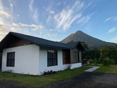a house with a mountain in the background at Hotel Campo Verde in Fortuna