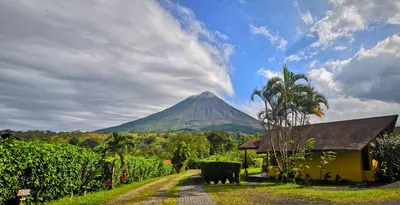 a mountain in the distance with a house and a road at Hotel Campo Verde in Fortuna