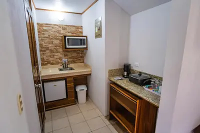 a small bathroom with a sink and a microwave at Hotel Campo Verde in Fortuna