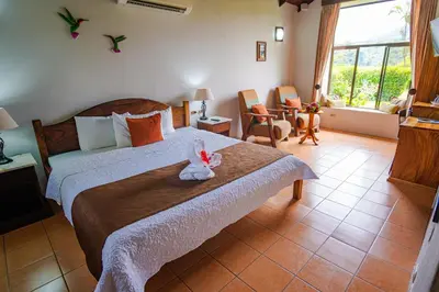 a bedroom with a bed with a stuffed animal on it at Hotel Campo Verde in Fortuna