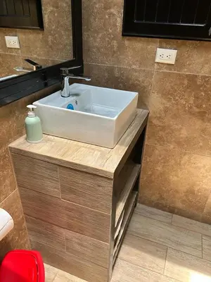a bathroom with a white sink and a mirror at Villas Paraíso Jacó B20 in Jacó