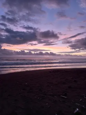 a sunset on a beach with the ocean at Villas Paraíso Jacó B20 in Jacó