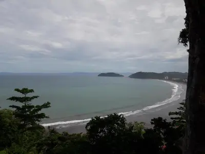 a view of a beach with mountains in the distance at Villas Paraíso Jacó B20 in Jacó