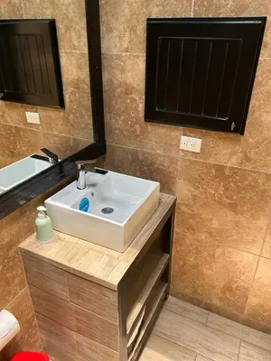a bathroom with a white sink and a mirror at Villas Paraíso Jacó B20 in Jacó