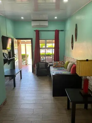 a living room with a couch and a table at Villas Paraíso Jacó B20 in Jacó