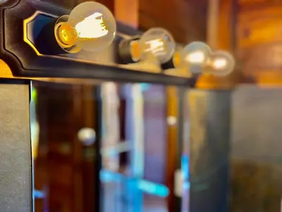 a row of books on a shelf with lights at Hoja Azul in Hojancha
